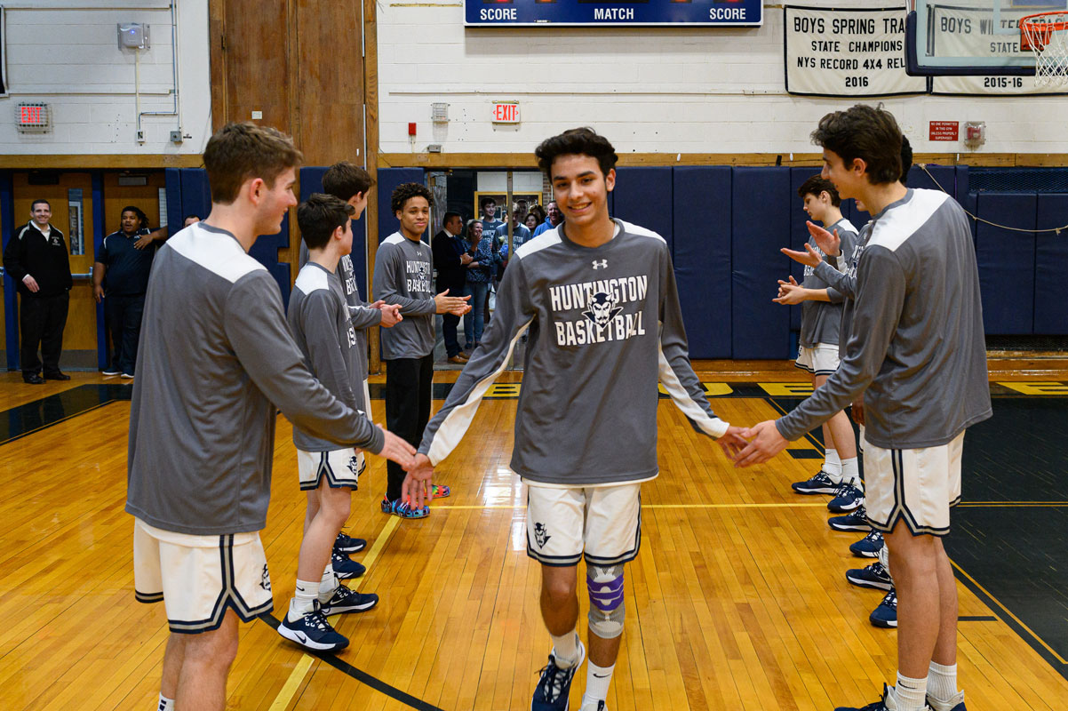 Renato Erek enters the gym on Blue Devil Senior Night. (Darin Reed photo.)