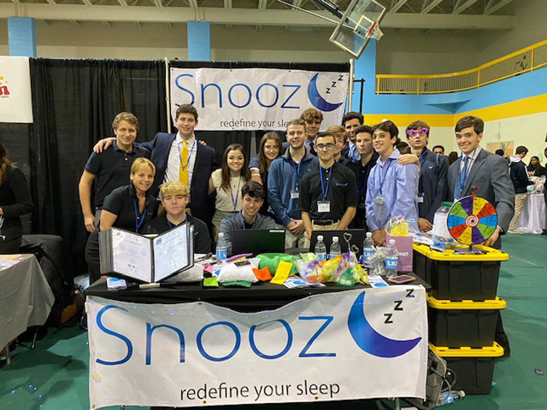 The Snooz³ team at the company booth at the trade show.