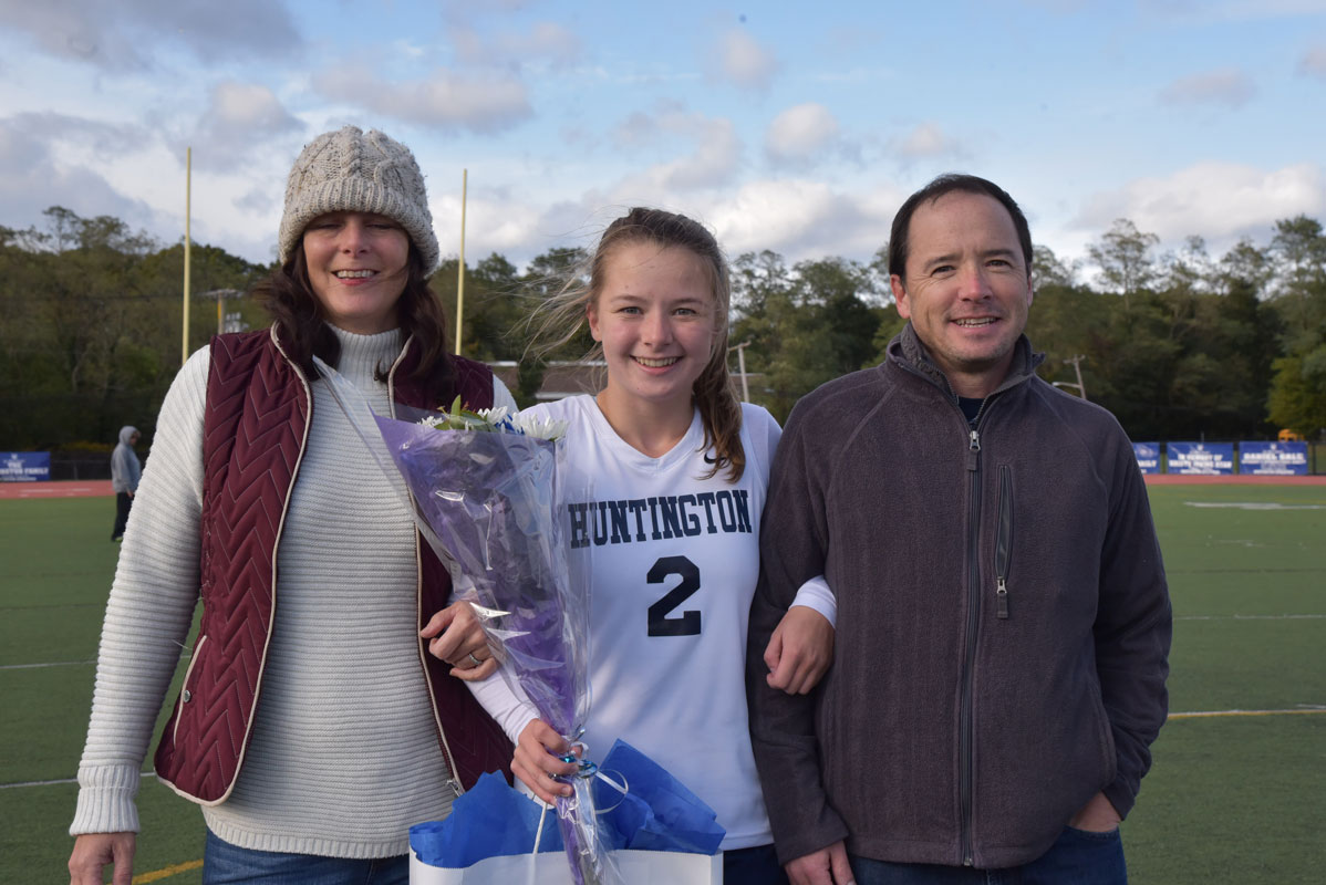 Maddy Kye with her parents on Huntington field hockey Senior Day 
