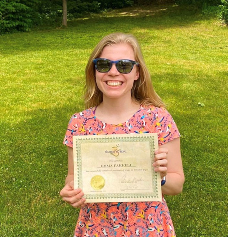 Emma Farrell holds a certificate of completion denoting she has completed a 200 hour traning program to teach yoga.