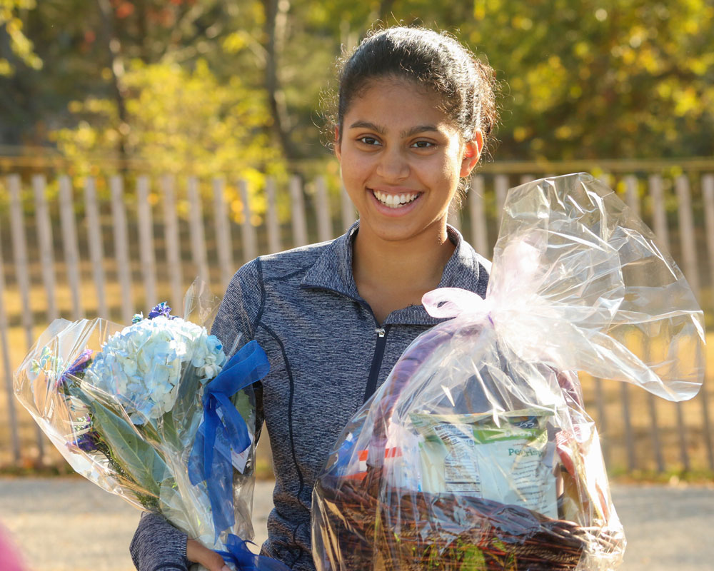 Diya Rai-Gersappe on Huntington girls' cross country Senior Day last fall 