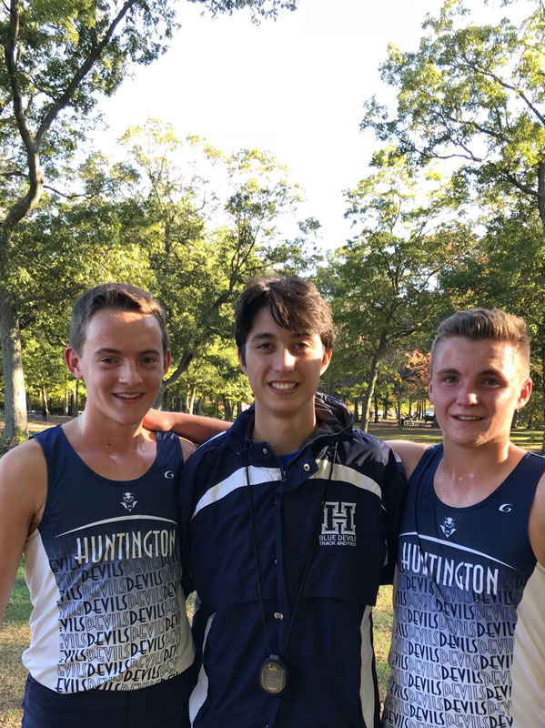 Jason Verville (left) with cross country teammates Ryan Smith and Graham Young at Belmont Lake State Park in October 2017.