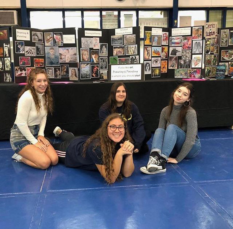 Caitlyn Palermo (second from left) with fellow high school artists at Finley Middle School to discuss art program offerings