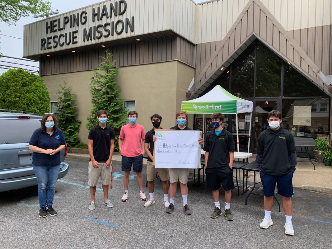 Huntington's BioSol Virtual Enterprise company presented a check to Helping Hand Rescue Mission.