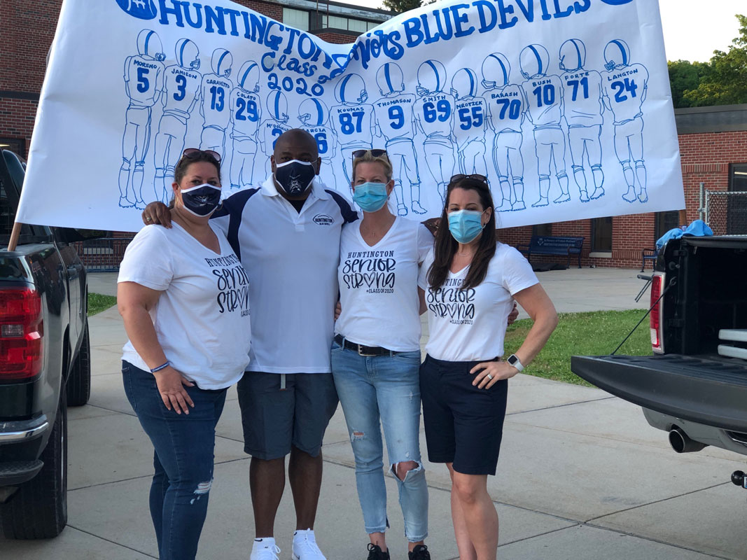 Coach Ron Wilson is flanked by Blue Devil football parents.