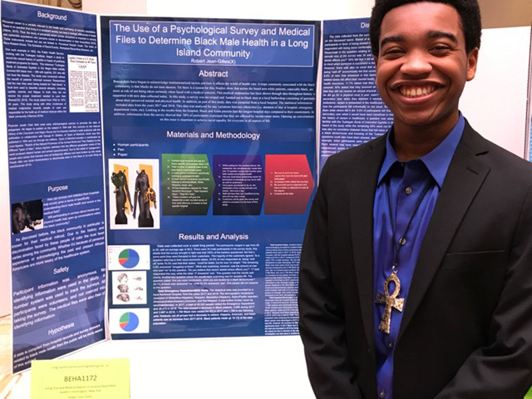 Huntington senior Robert Jean-Gilles with his project at the LI Science and Engineering Fair.