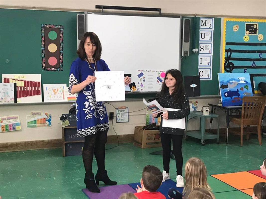 Flower Hill Principal Lucia Laguarda with students who showed off their pieces of art