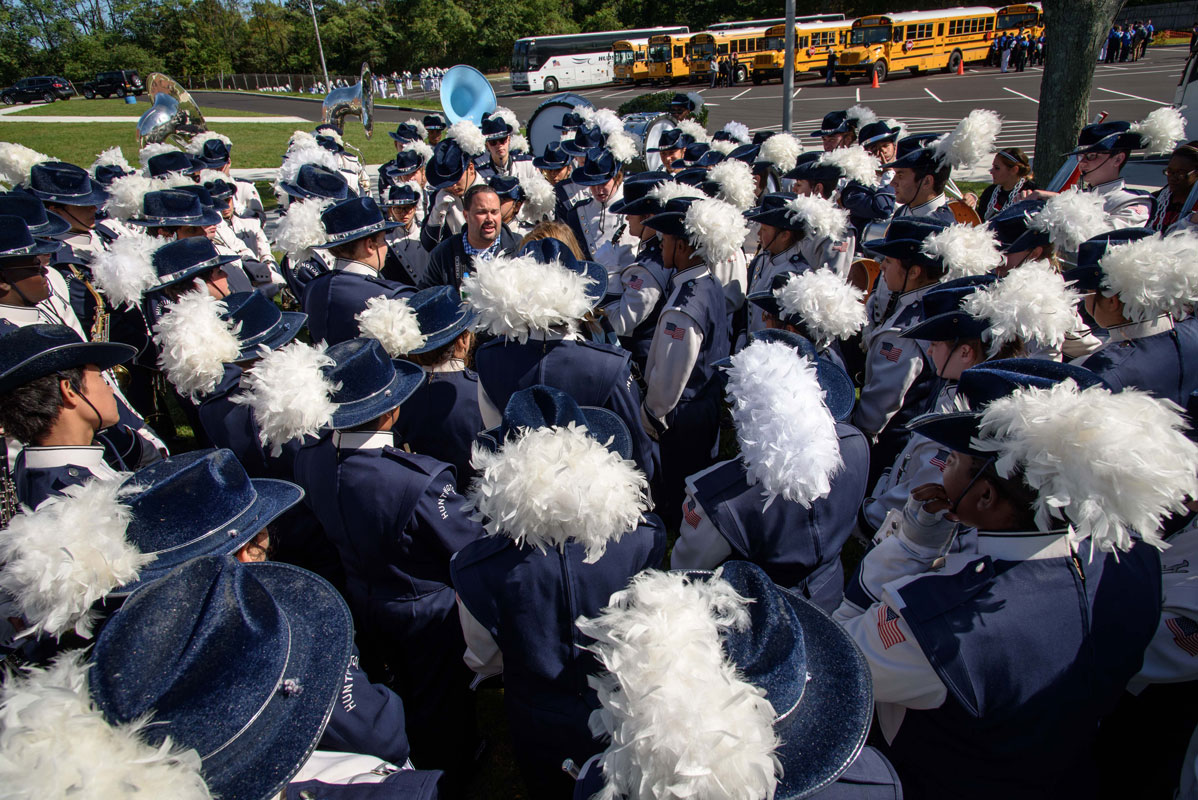 The Blue Devil marching band surrounds Brian Stellato. (Darin Reed photo.)