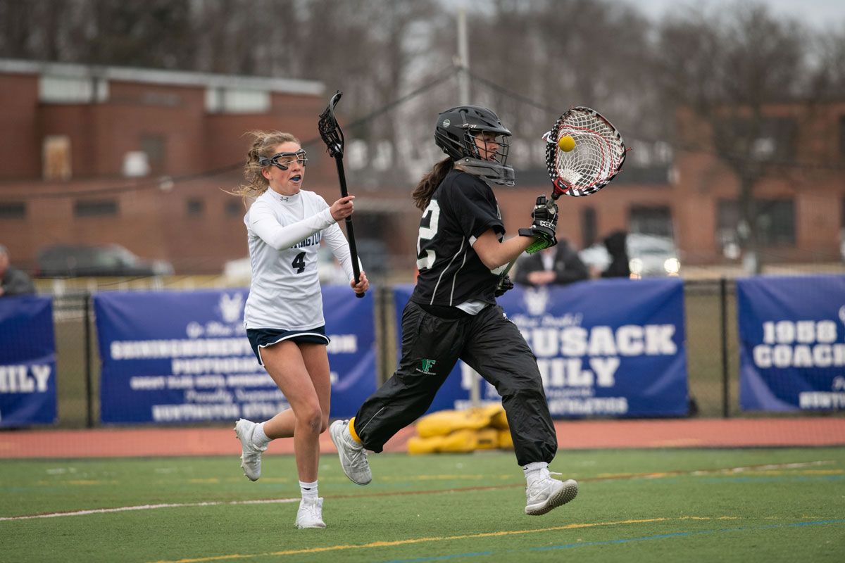 Katie Browne (left) chases down the goalie. (Darin Reed photo.)