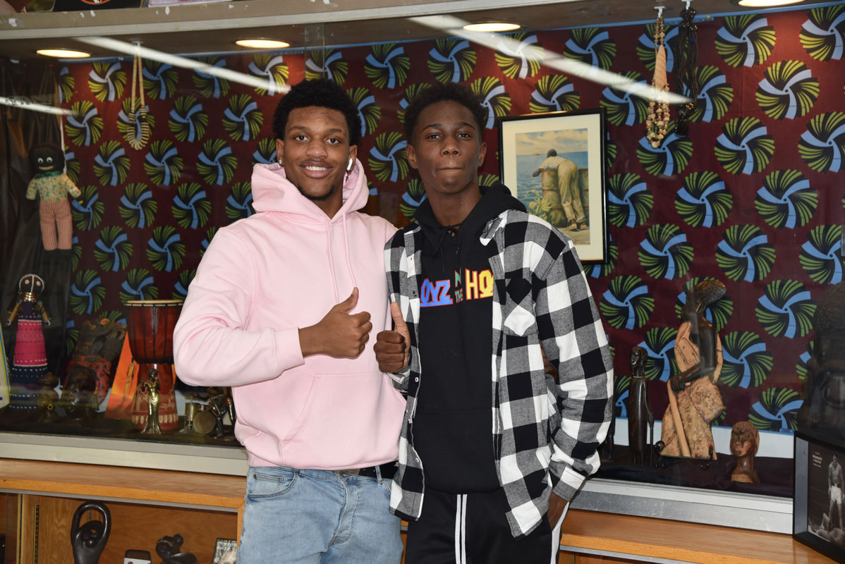 Tyriek Mays-McKoy and Quincy Chery near the Black History Month display 