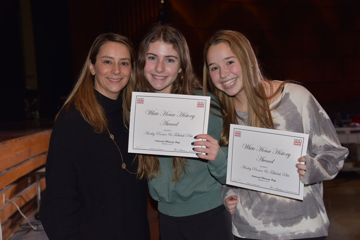 Tallulah Pitti (center) and Ainsley Proctor with Huntington social studies teacher Lauren Desiderio 
