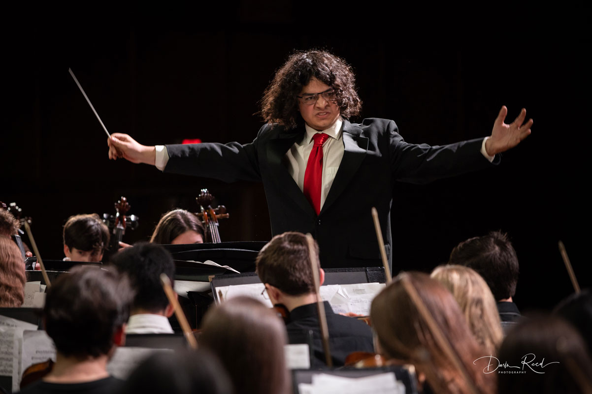Senior Kyle Perea directs the orchestra at last December's winter concert. (Darin Reed photo)