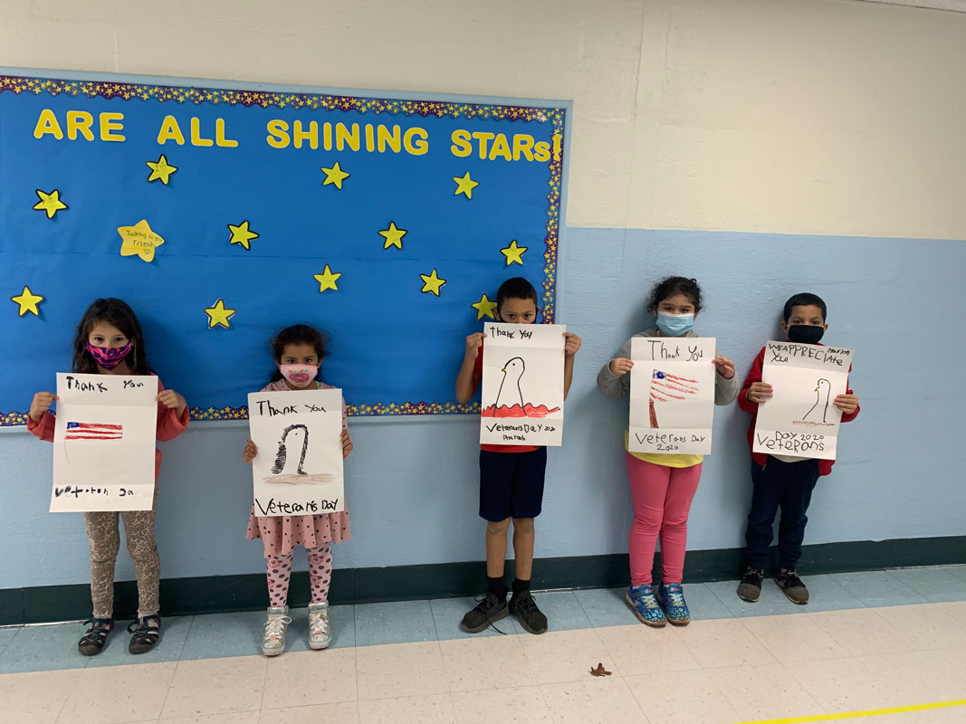 Flower Hill second graders hold their posters.