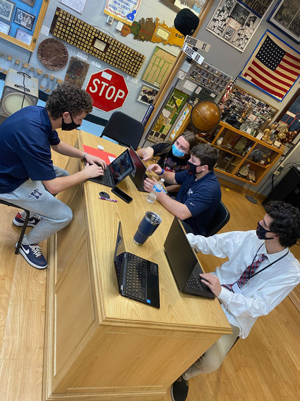  HomeTown team members are shown working in the School Heritage Museum. 