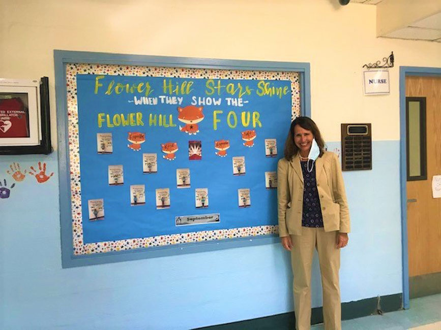 Flower Hill Principal Lucia Laguarda near the Star Student Award bulletin board.