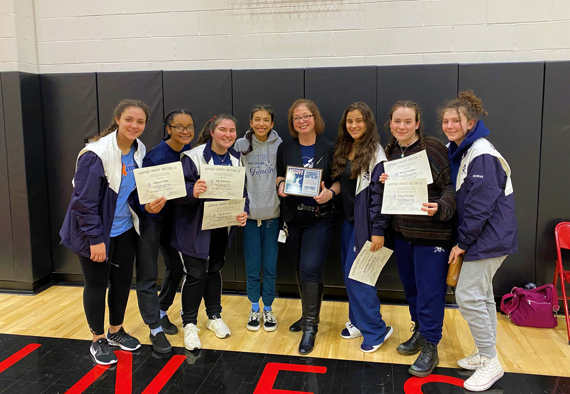 Blue Devil sabre and foil fencers flank head coach Michelle O'Brien at last year's county championships.