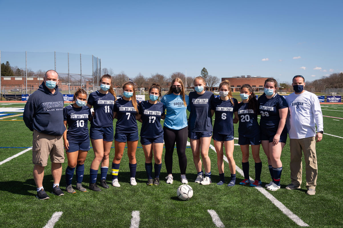 Coaches John Walsh and Vinny Tannazzo with the 2021 seniors. (Darin Reed photo.)