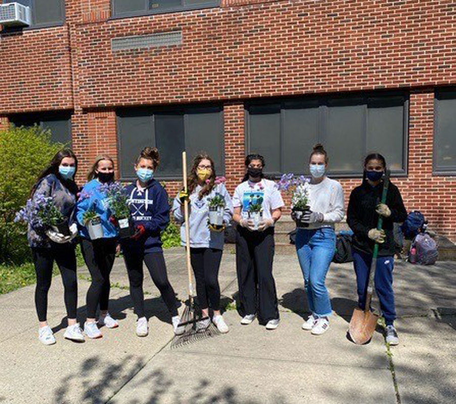Huntington High School Environmental Club members have shovels and plants and are ready to work.