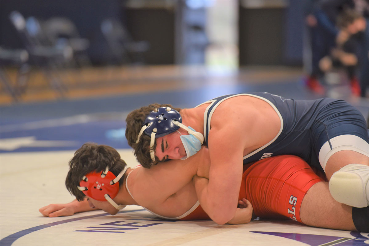 Lucas Petrizzi (top) works to secure a bar arm.