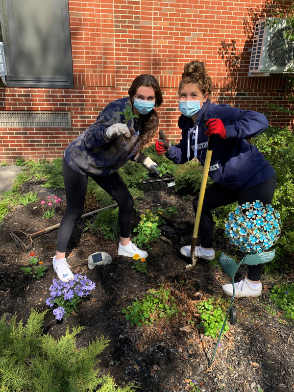 The Huntington environmental club members had fun sprucing up Eli's Garden 