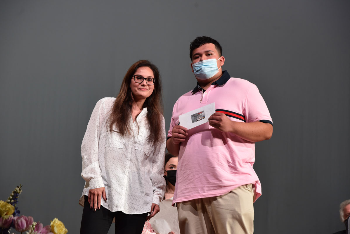 Guidance counselor Diana Bonilla presented the AloeTech scholarship to Class of 2021 member Andys Saravia-Ramirez 