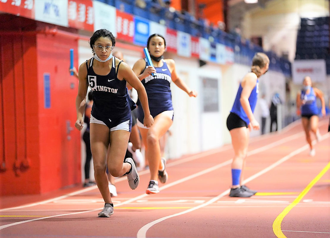 Brianna Halbeisen hands the baton to Analisse Batista in the 4x200m relay.