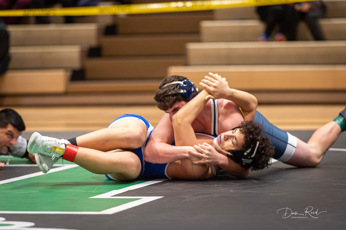 Huntington senior Lucas Petrizzi nears another pin. (Darin Reed photo.)
