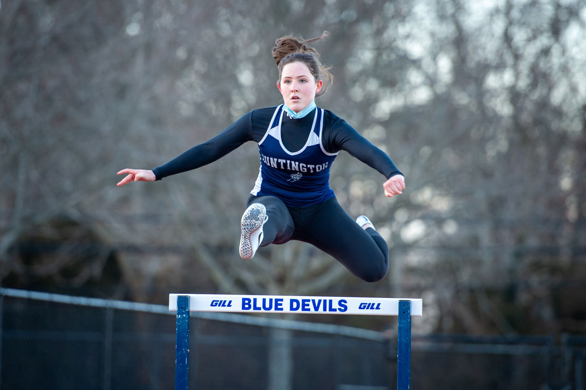 Caroline O'Rourke sails over a hurdle for Huntington. (Darin Reed photo.)