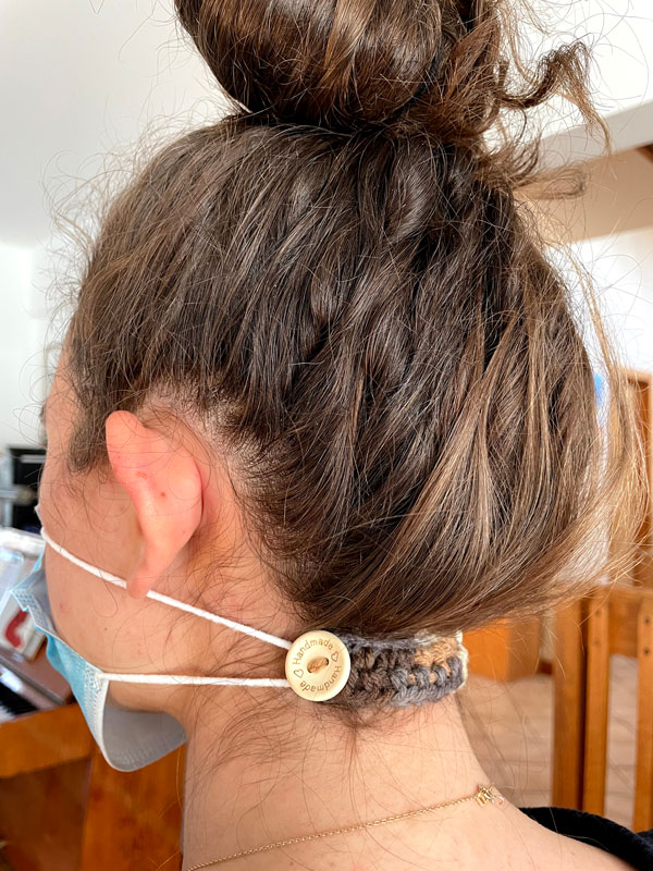 The New World Club is selling crocheted ear savers that attach to face masks 