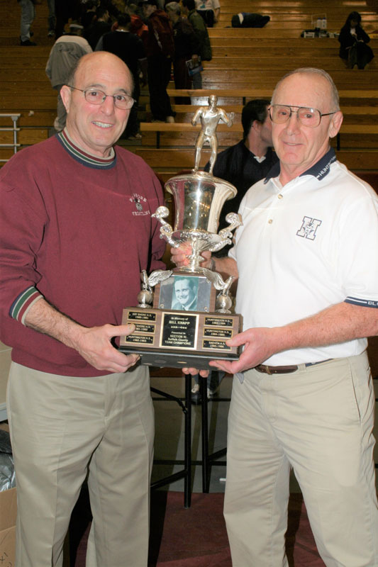 Lou Giani accepts the county championship trophy from Bay Shore coach Jumper Leggio at the 2004 Section XI at Stony Brook University.