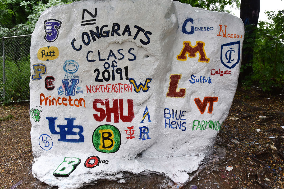 The parents of seniors painted The Rock with the colleges their child would be attending.