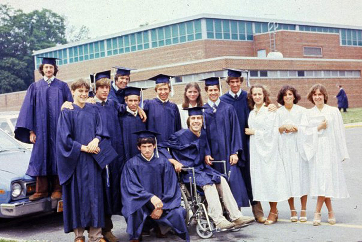 Peter Steen in his wheelchair surrounded by fellow graduates in June 1979.