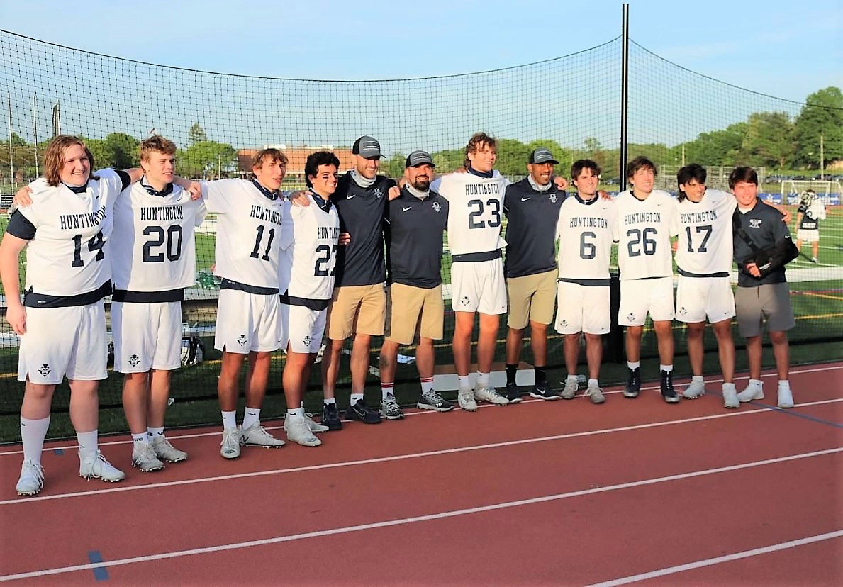 The nine Blue Devil seniors with their coaches.