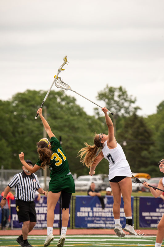 Both teams reach for the faceoff ball. (Darin Reed photo.)
