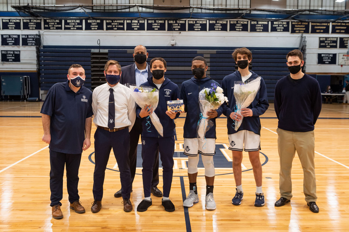 Seniors Adrian Brooks, Chad Rowe and Zach Gordon with Blue Devil basketball coaches. (Darin Reed photo.)