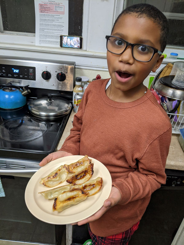 Dashawn Grant with a plate of delicious dumplings.