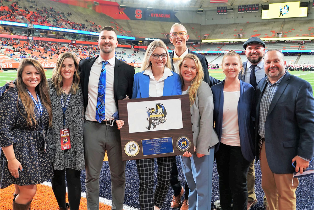 The Blue Devil marching band's staff with the third place award. (Gregg Geller photo.)