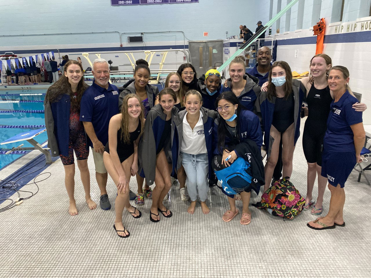Coaches, swimmers and divers at the pool.