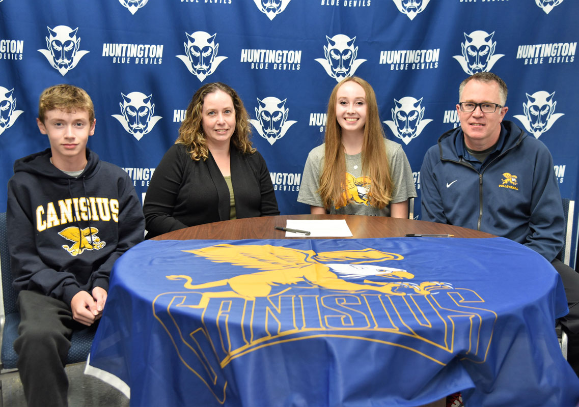 Shannon Kehoe is surrounded by her family at her letter of intent signing in the high school athletic office. 