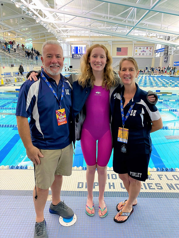 Caelan Clayton with Coaches Chris Helmke and Meg McConnell.