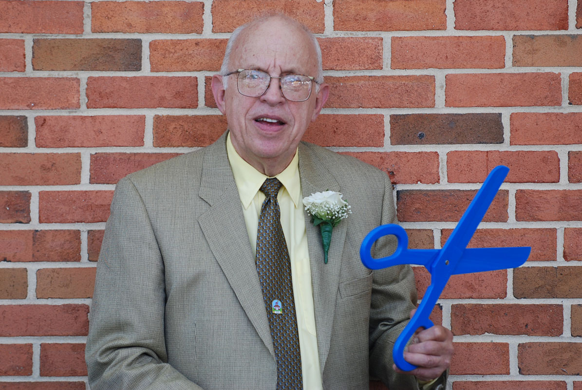 Jack Abrams with the scissors used to cut the ribbon outside the school named in his honor.