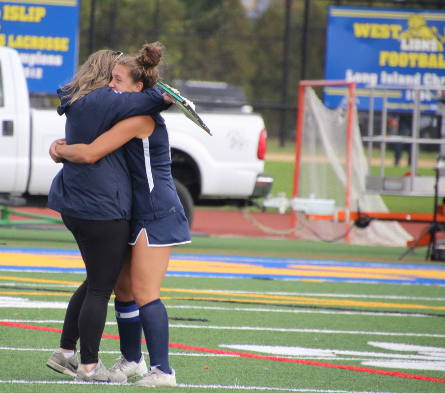 Assistant coach Allison Conlon and Laurel Bonn hug it out after the OT win. (Stacey Byrnes photo.)