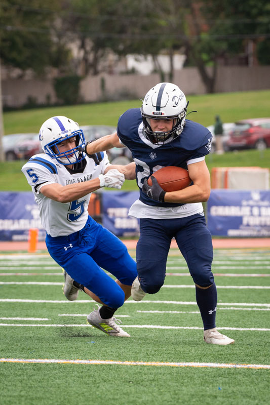 Sophomore Christian St. John breaks a tackle. (Darin Reed photo.)
