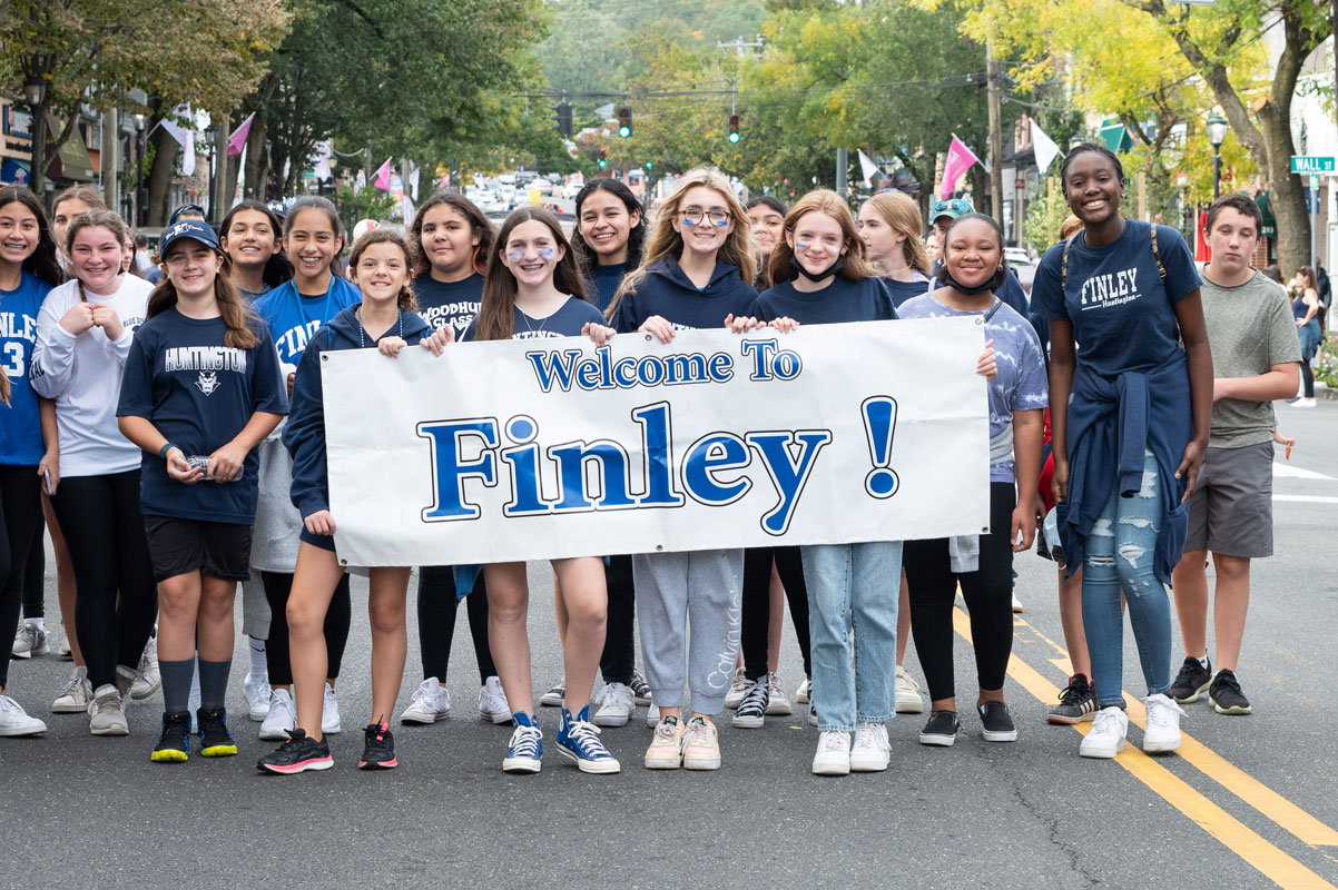 Students, teachers and parents marched in the parade behind school banners. (Darin Reed photo.)