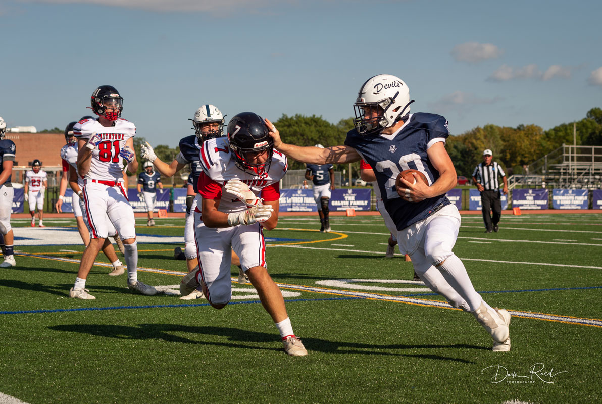 Sophomore Christian St. John applies a classic straight arm on the would be tackler. (Darin Reed photo.)