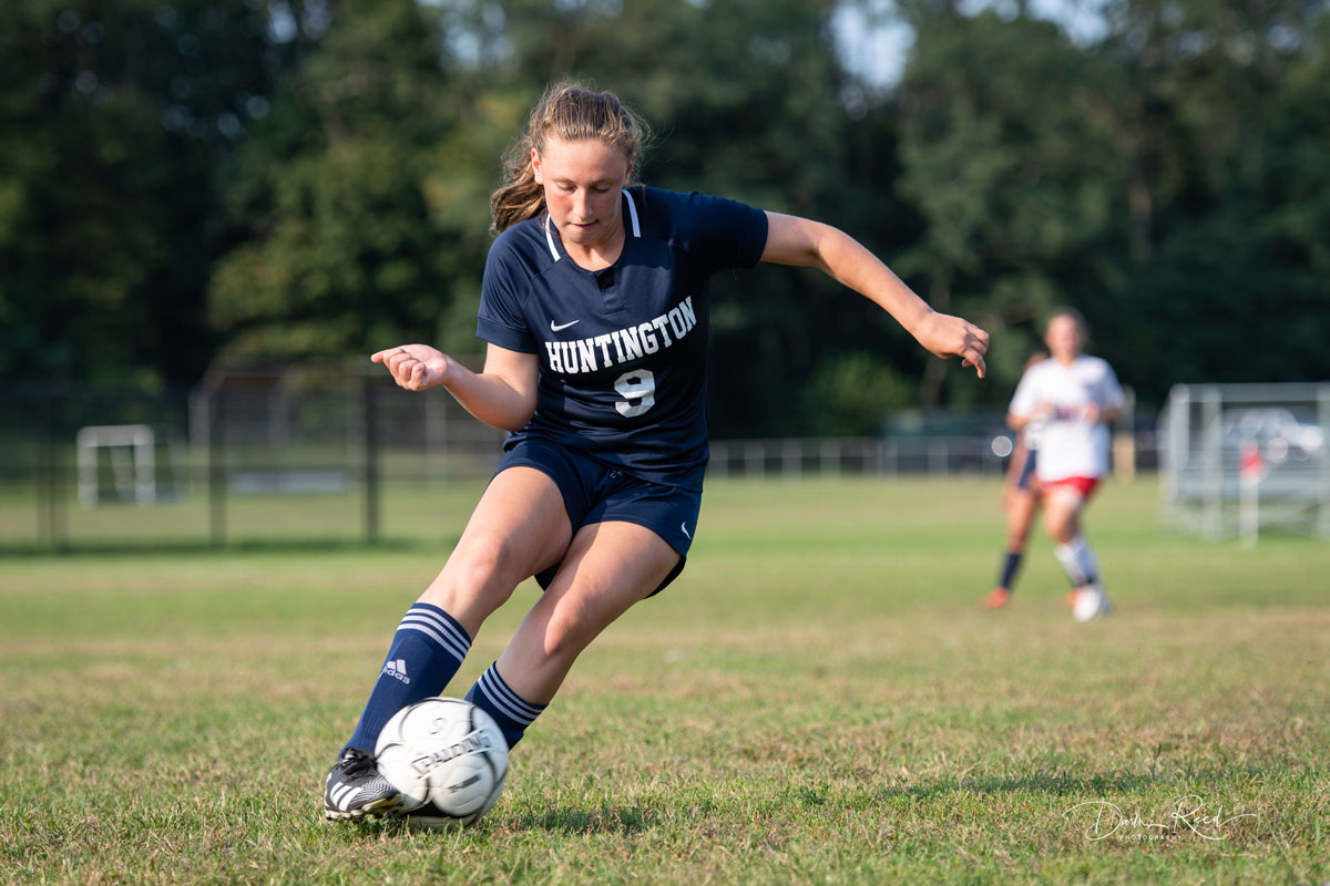 Eighth grader Jolie Weinschreider with the ball for the Blue Devil varsity. (Darin Reed photo.)