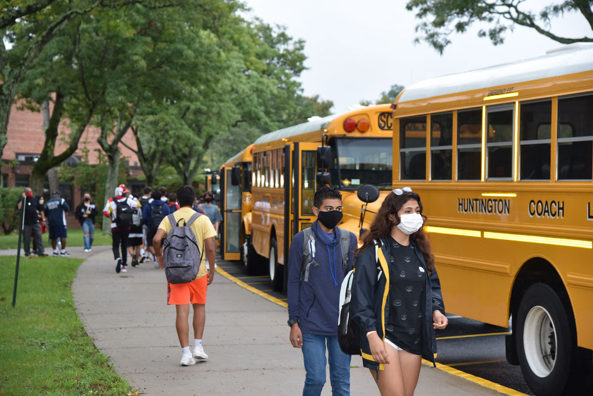Students head to their respective bus at the dismissal bell at the high school 
