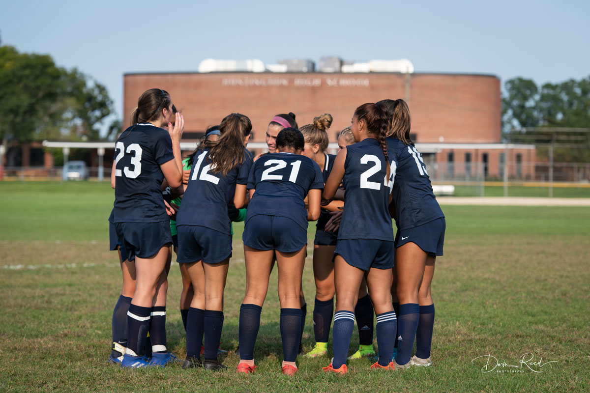 The Huntington girls' soccer team huddles. (Darin Reed photo.)