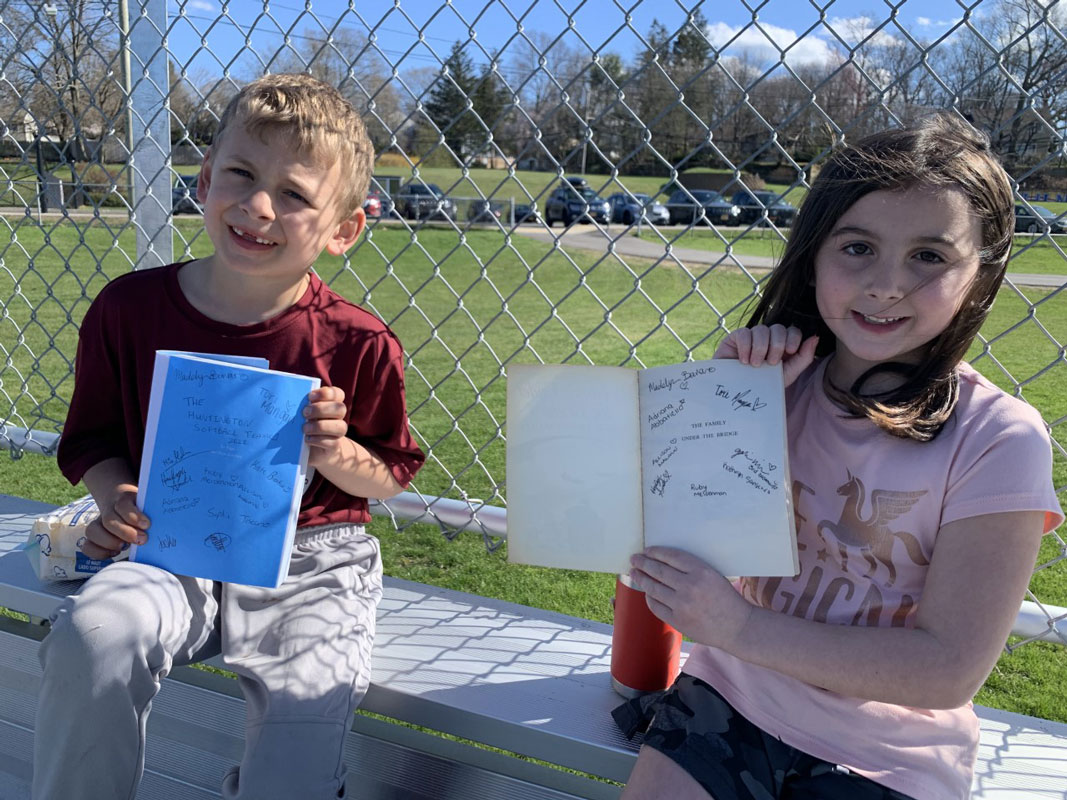 Hunter Schmale and Madeline Leiter show off their softball player autographs.