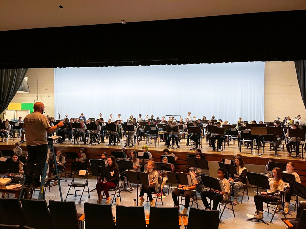 Finley music teacher Frank Battista works with a Band Fest group of musicians.